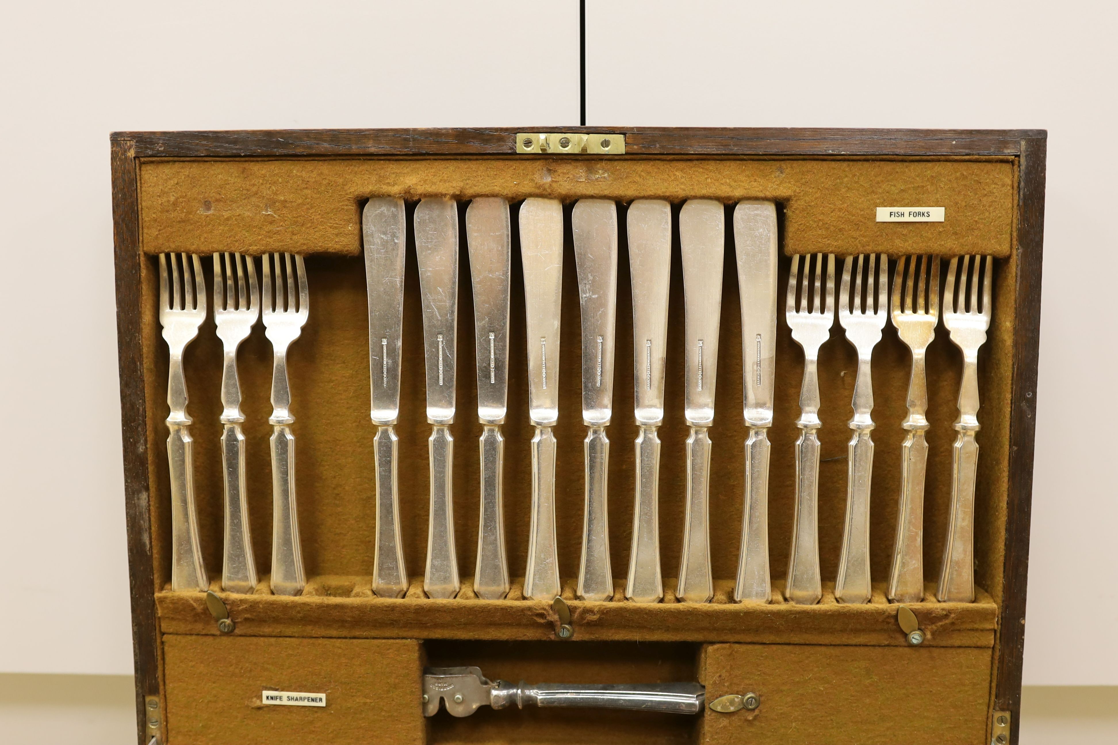 A pair of plated telescopic candlesticks and a Mappin & Webb part canteen of plated cutlery